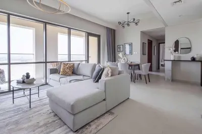 a living room with a couch and a table at Frank Porter - Vida Creek Beach in Dubai