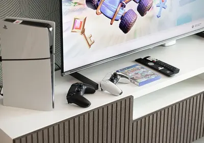 a desk with a computer monitor and a remote control at Stylish Flat in Downtown Dubai with PS5 Gym and Pool in Dubai