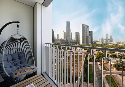 a swing on a balcony with a view of a city at Stylish Flat in Downtown Dubai with PS5 Gym and Pool in Dubai