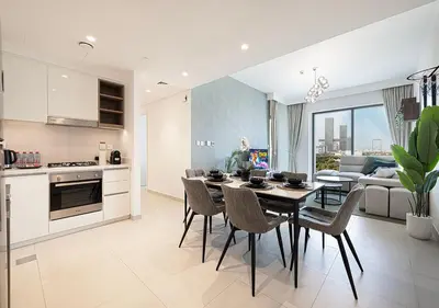a kitchen and dining room with a table and chairs at Stylish Flat in Downtown Dubai with PS5 Gym and Pool in Dubai