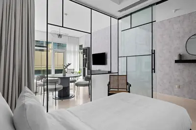 a bedroom with a white bed and a dining room at 1BR with Study City View in Bay Square B13 in Dubai