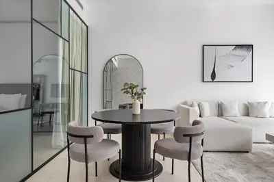 a living room with a table and chairs at 1BR with Study City View in Bay Square B13 in Dubai