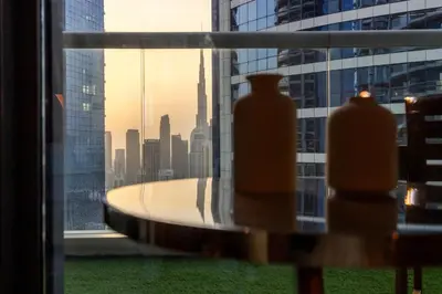 two vases sitting in a window with a view of a city at Dubai Paramount 1BR APT Burj Khalifa view in Dubai