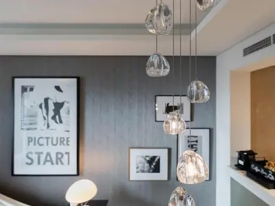 a room with several lights and pictures on the wall at Dubai Paramount 1BR APT Burj Khalifa view in Dubai