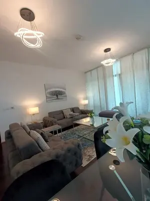 a living room with a couch and a table at Quill Residence - Canal View Spacious 3 bedroom Apartment in Dubai