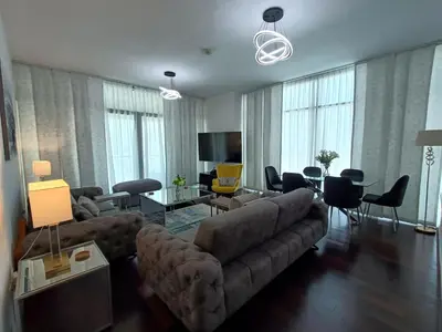 a living room with a couch and a table at Quill Residence - Canal View Spacious 3 bedroom Apartment in Dubai