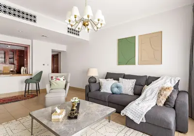 a living room with a couch and a table at 5 Min Walk to Burj Khalifa 2BHK Luxury Downtown Burj Haven in Dubai
