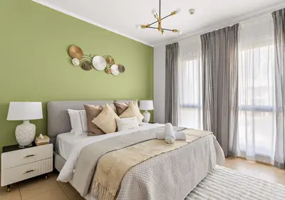a bedroom with a large bed with green walls at 5 Min Walk to Burj Khalifa 2BHK Luxury Downtown Burj Haven in Dubai