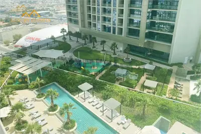 an aerial view of a resort with a swimming pool at Elegant 2-BR with Canal & City Views Pool Amenities in Dubai