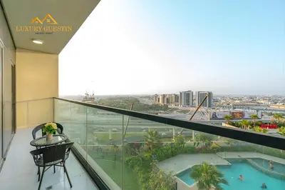 a balcony with a view of a resort at Elegant 2-BR with Canal & City Views Pool Amenities in Dubai