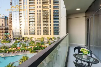 a balcony with a view of a resort at Elegant 2-BR with Canal & City Views Pool Amenities in Dubai