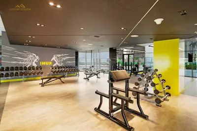 a gym with exercise equipment in a building at Elegant 2-BR with Canal & City Views Pool Amenities in Dubai