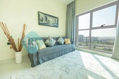 a living room with a couch and a large window at Bloomfields Modern 1bedroom In Wavez in Dubai
