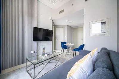 a living room with a couch and a table at Elegant Escapes - Lavish 1B,Dubai Water Canal View in Dubai