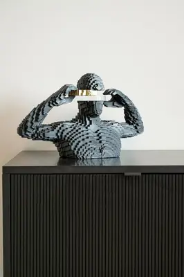 a metal sculpture of a man with his hands on his head at LUXE | Luxury 2BR | Creek View | Modern & Cozy in Dubai