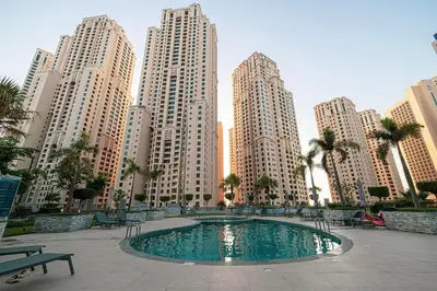 a pool in the middle of a city with tall buildings at A Marina Luxe Retreat in Dubai