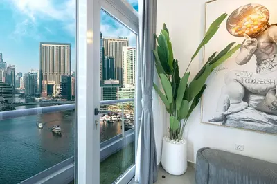 a room with a window with a view of the city at A Marina Luxe Retreat in Dubai