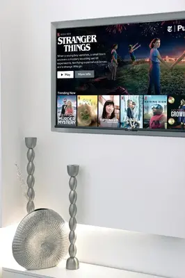 a shelf with a bunch of dvd movies at A Marina Luxe Retreat in Dubai