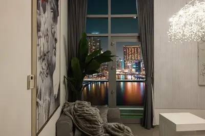 a room with a window with a view of a city at A Marina Luxe Retreat in Dubai