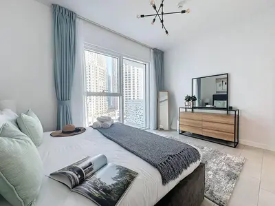 a bedroom with a large bed with a large window at La Vie JBR Gorgeous One Bedroom Beach Access Panoramic Pool in Dubai