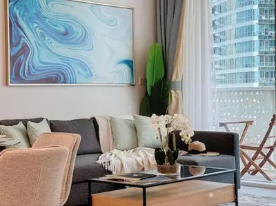 a living room with a couch and a table at La Vie JBR Gorgeous One Bedroom Beach Access Panoramic Pool in Dubai