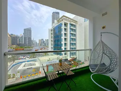 a balcony with a swing and a view of a city at Luxury Studio w Marina View & New Furnishings for 4 Pax in Dubai