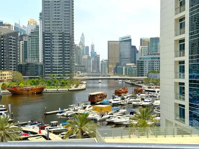 a view of a city with boats in a harbor at Luxury Studio w Marina View & New Furnishings for 4 Pax in Dubai
