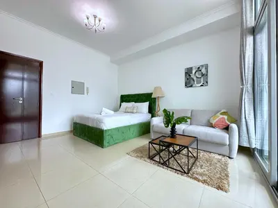 a living room with a couch and a table at Luxury Studio w Marina View & New Furnishings for 4 Pax in Dubai