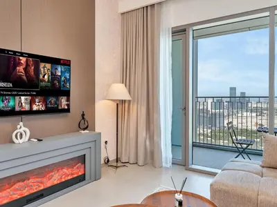 a living room with a fireplace and a large window at BRAND-NEW 1BR in DOWNTOWN I Direct DUBAI MALL Access I Balcony & Stunning Pool in Dubai