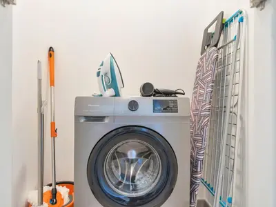 a washer and dryer in a laundry room at BRAND-NEW 1BR in DOWNTOWN I Direct DUBAI MALL Access I Balcony & Stunning Pool in Dubai