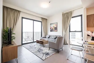 a living room with a couch and a table at Executive Residence-Dubai Hills by Serenity Living in Dubai