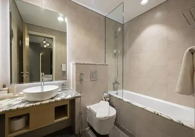 a bathroom with a sink and a toilet and a tub at 5 Star High Rise Luxury Apartment, Infinity Pool With Stunning Burj View - Brand New Apartment in Dubai