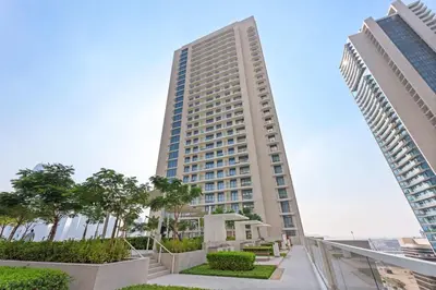 a tall building in the middle of two buildings at Silkhaus 1BDR in Marina Vista with Private Beach in Dubai