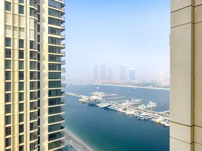 a view of a harbor between two tall buildings at Silkhaus 1BDR in Marina Vista with Private Beach in Dubai