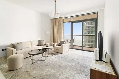 a living room with a couch and a tv at Silkhaus 1BDR Marina Vista with Private Beach Access in Dubai