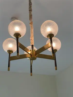 a pair of lights hanging from a ceiling at Peaceful Studio Getaway in Liwan in Dubai