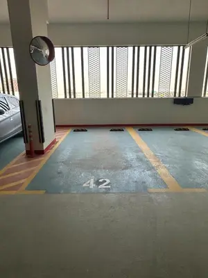 an empty parking lot with a car parked in it at Peaceful Studio Getaway in Liwan in Dubai