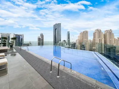 a large swimming pool on the roof of a building at Luxe Central Marina Studio with Rooftop Pool in Dubai