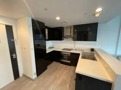 a kitchen with a sink and a counter top at Damac canal views building in Dubai