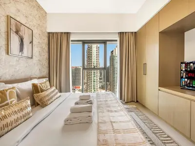 a hotel room with a large white bed and a large window at Luxury 1BR, 5 Min walk to Dubai Mall & Burj Khalifa, Can Sleep 1-4 in Dubai