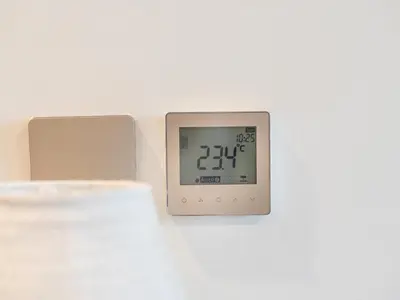 a clock on a white wall with a clock on it at Luxury 1BR, 5 Min walk to Dubai Mall & Burj Khalifa, Can Sleep 1-4 in Dubai