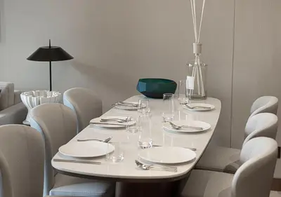 a white table with white plates and glasses on it at Luxurious 2BR at Address Opera with Boulevard Views in Dubai