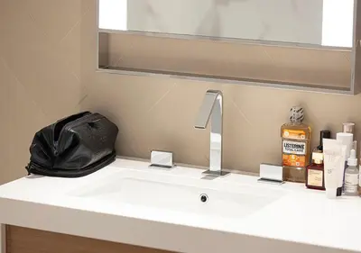 a bathroom sink with a purse sitting on top of it at Luxurious 2BR at Address Opera with Boulevard Views in Dubai