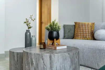 a living room with a table with a plant on it at ShoresInn - Luxury 1BR with Marina View in Dubai