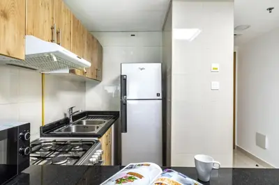 a kitchen with a sink and a refrigerator at ShoresInn - Luxury 1BR with Marina View in Dubai