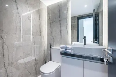 a bathroom with a toilet and a sink at Elegant & Cozy 2BR Home in the Heart of Downtown in Dubai