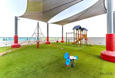 a play area with a playground with a tent at Stylish 1BR Apartment at Orchid Residence, Al Barsha South by Deluxe Holiday Homes in Dubai