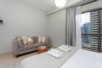 a living room with a large bed and a couch at GuestReady - Marvellous getaway in Dubai Marina in Dubai