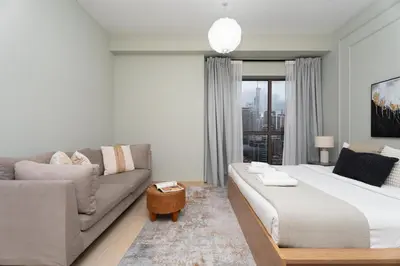 a living room with a large bed and a couch at GuestReady - Marvellous getaway in Dubai Marina in Dubai