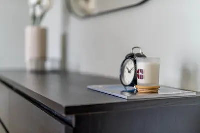 a cup of coffee and an alarm clock on a desk at GuestReady - Marvellous getaway in Dubai Marina in Dubai